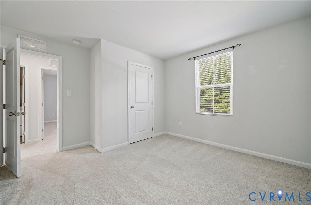 5713 Bison Ford Court, Chesterfield, VA 23234 Neutral tone wall paint, light-colored carpeting, white trim, and a window with blinds