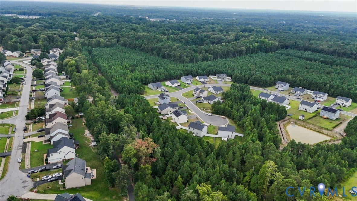 5713 Bison Ford Court, Chesterfield, VA 23234 Residential community with varied housing styles, surrounded by extensive natural tree coverage, featuring established streets and a community pond