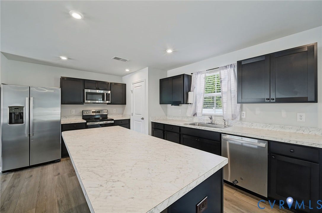 5713 Bison Ford Court, Chesterfield, VA 23234 Kitchen featuring dark cabinetry, light countertops, wood-finish flooring, recessed lighting, and stainless steel appliances