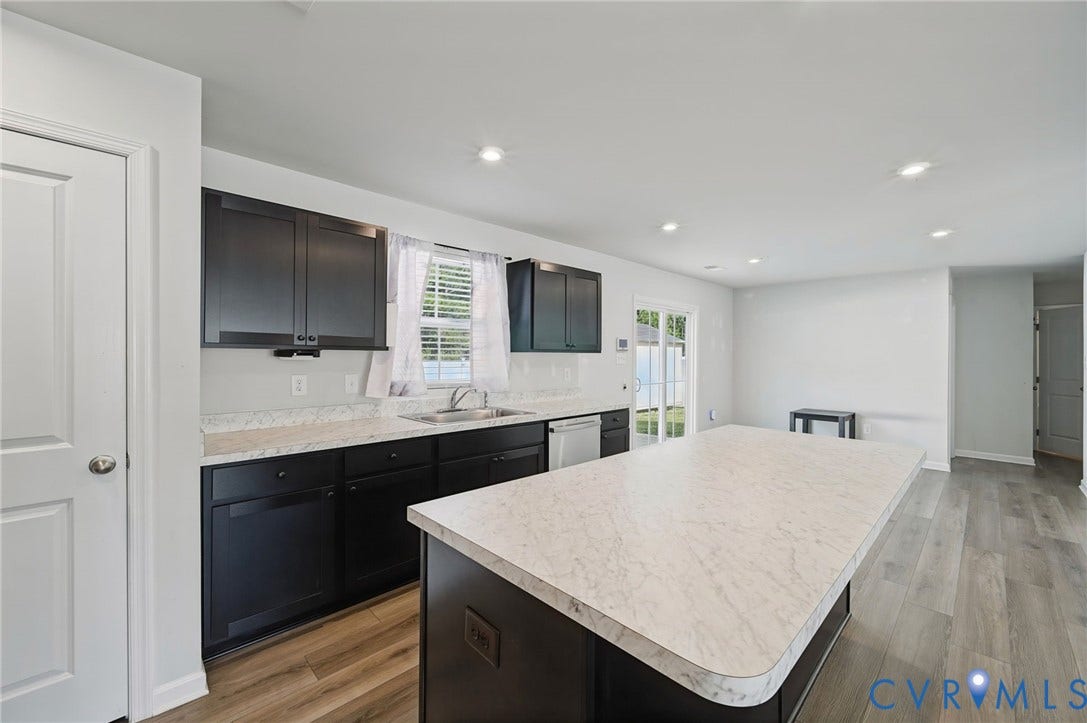 5713 Bison Ford Court, Chesterfield, VA 23234 Kitchen featuring dark cabinetry, light countertops, stainless steel sink, recessed lighting, and wood-finish flooring