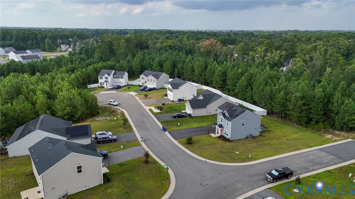 5713 Bison Ford Court, Chesterfield, VA 23234 Residential properties featuring asphalt driveways, green lawns, and mature trees surrounding a paved street