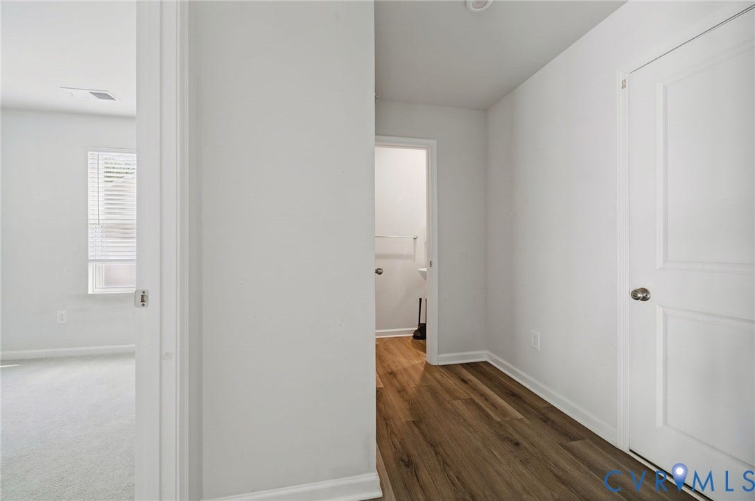 5713 Bison Ford Court, Chesterfield, VA 23234 Wood-finish flooring, white paneled doors, and a window with blinds