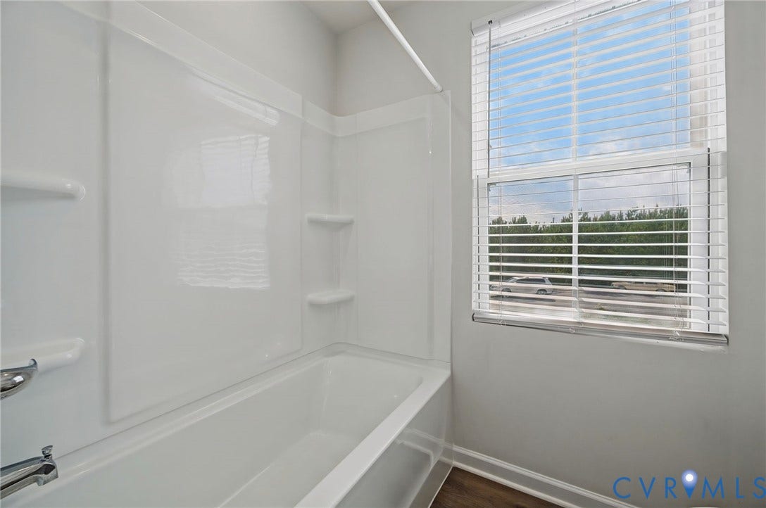 5713 Bison Ford Court, Chesterfield, VA 23234 Bathtub with integrated shower surround, built-in shelving, and a window with blinds