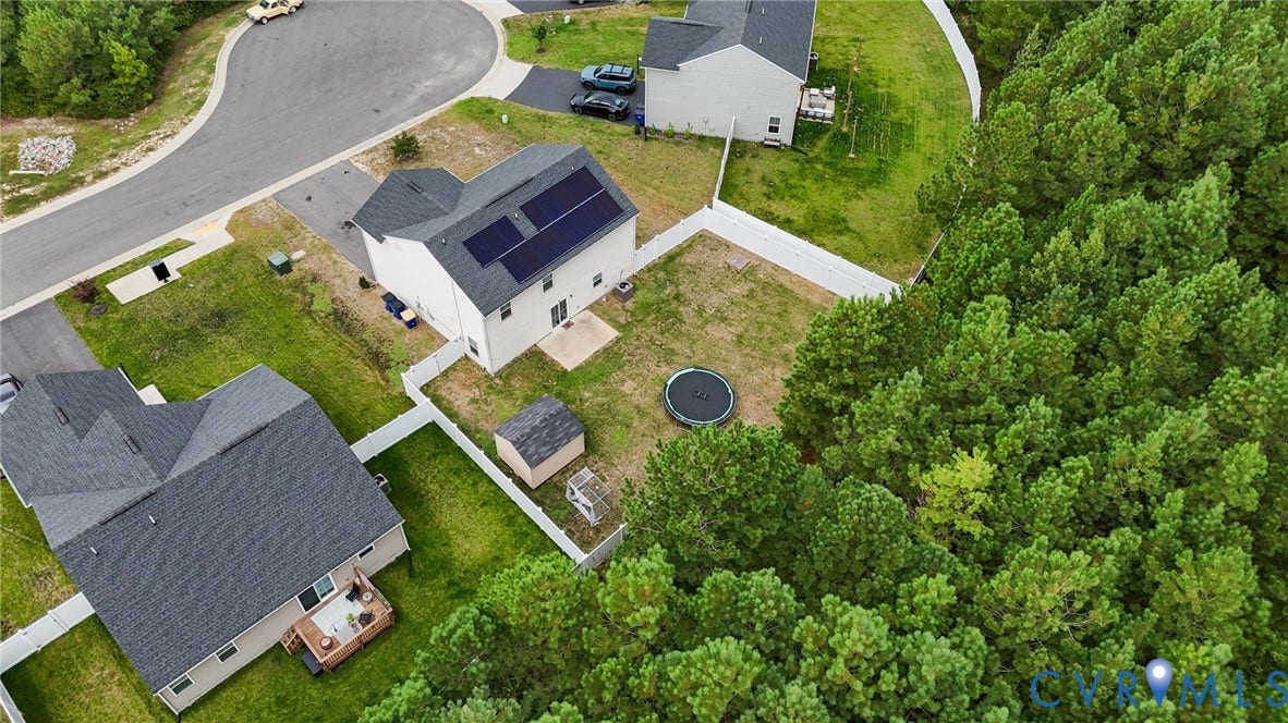 5713 Bison Ford Court, Chesterfield, VA 23234 Rear exterior featuring a fenced yard, mature trees, concrete patio, and a storage shed