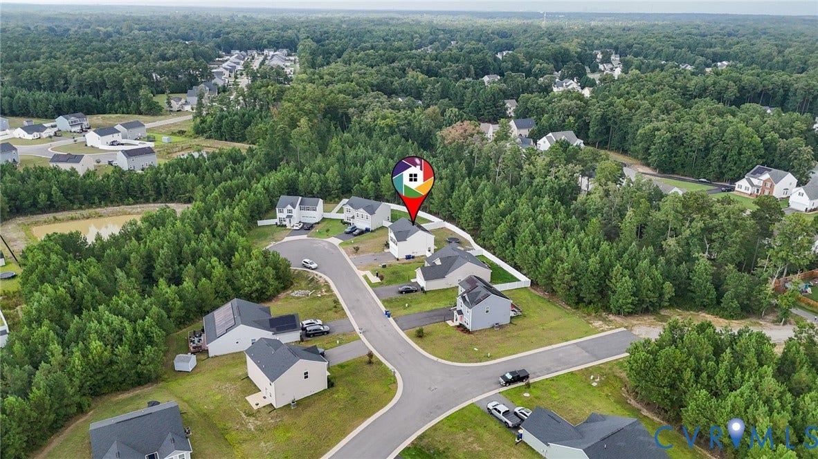 5713 Bison Ford Court, Chesterfield, VA 23234 Aerial depiction of a residential community featuring cul-de-sac streets, a natural pond, and extensive surrounding woodland