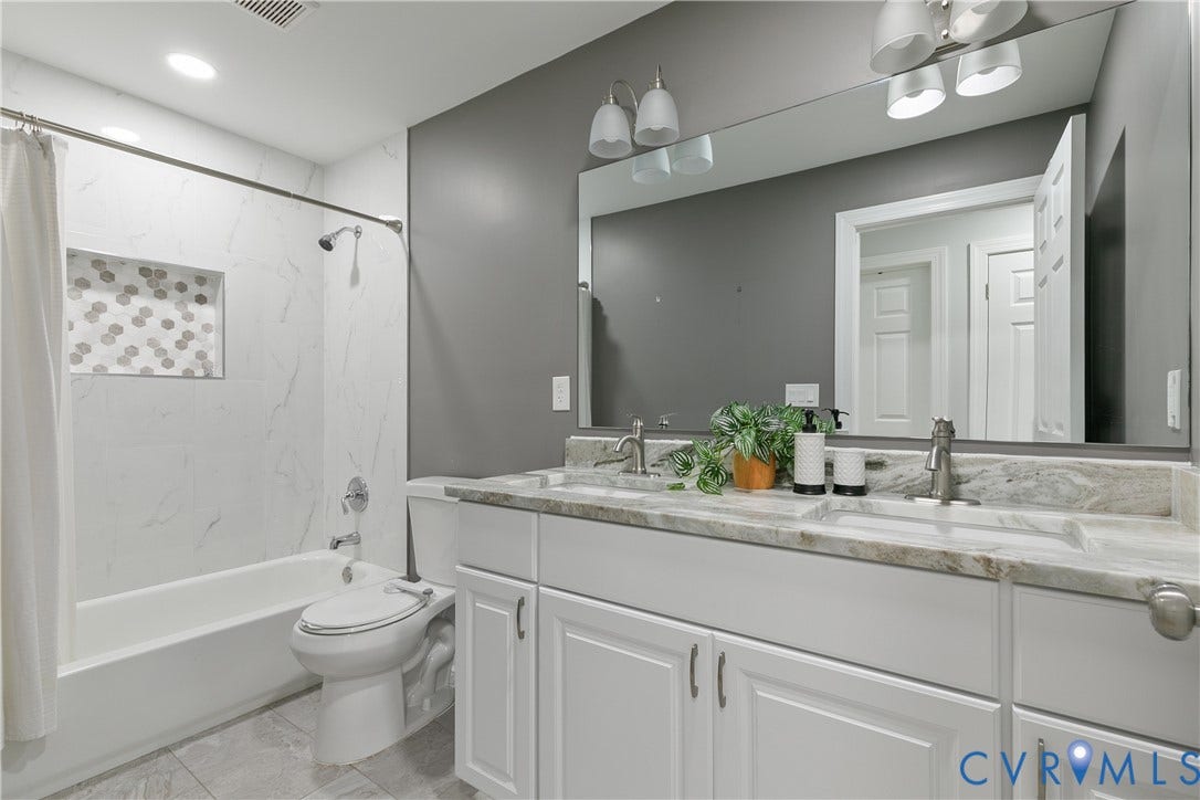 2203 Wedgewood Avenue, Henrico, VA 23228 Dual vanity with undermount sinks, stone countertop, and brushed nickel fixtures