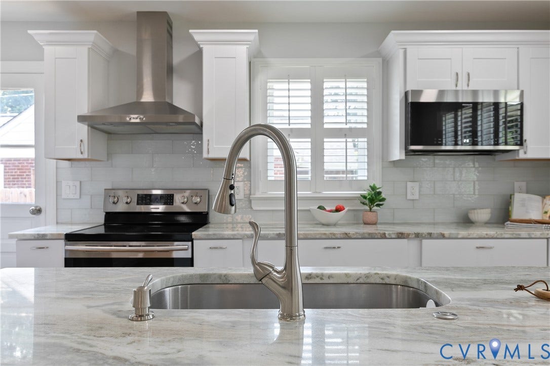 2203 Wedgewood Avenue, Henrico, VA 23228 Stainless steel kitchen appliances, white cabinetry with crown molding, light-toned countertops, and a subway tile backsplash