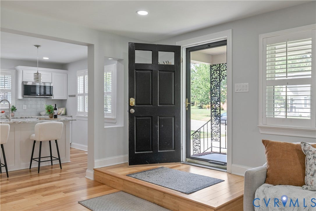 2203 Wedgewood Avenue, Henrico, VA 23228 Wood-finish flooring throughout, white plantation shutters, and a kitchen featuring white cabinetry, a light-toned countertop, and a tile backsplash