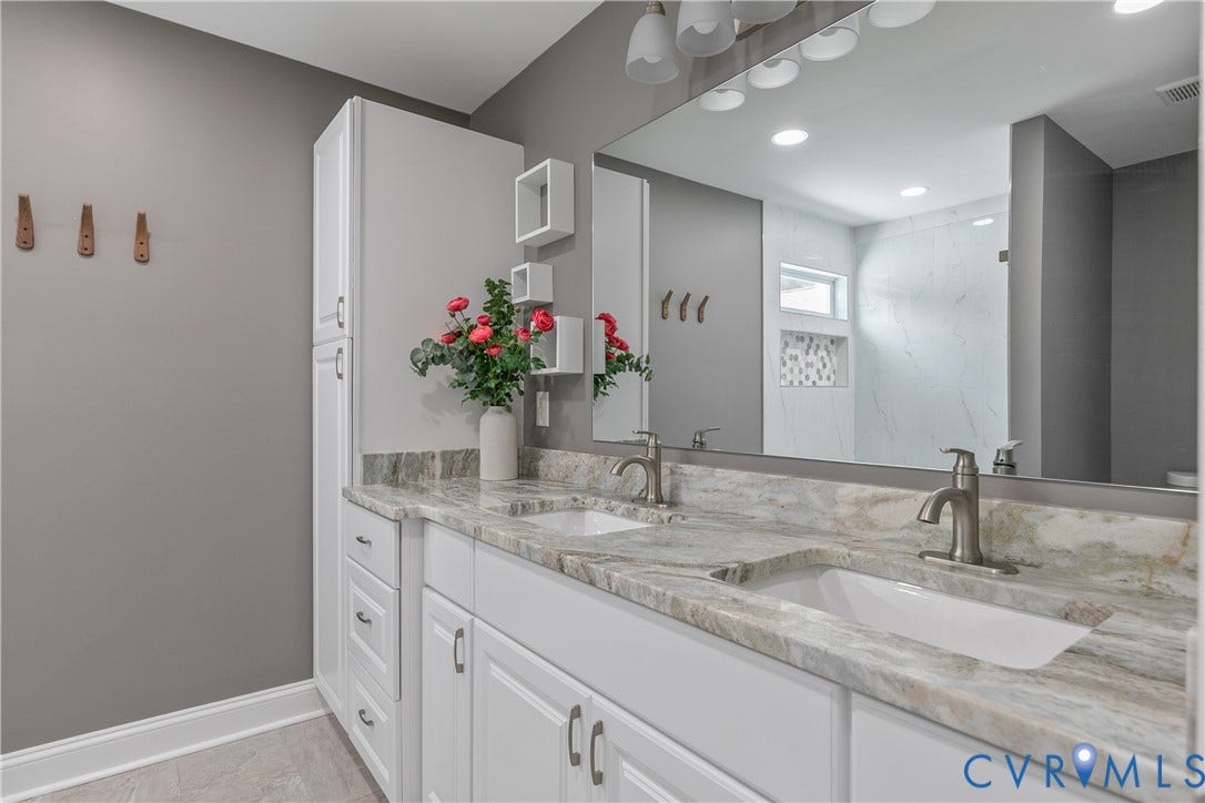 2203 Wedgewood Avenue, Henrico, VA 23228 Dual vanity with integrated sinks, brushed nickel fixtures, and a stone-finish countertop