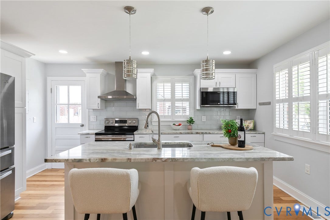 2203 Wedgewood Avenue, Henrico, VA 23228 Kitchen featuring white cabinetry, light-toned countertops, stainless steel appliances, and wood-finish flooring