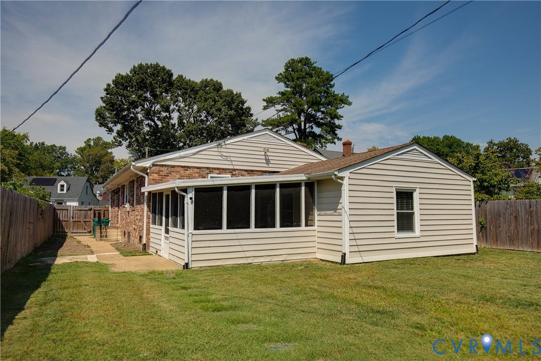 2203 Wedgewood Avenue, Henrico, VA 23228 Expansive backyard featuring a screened-in porch, natural wood fencing, and a concrete pathway