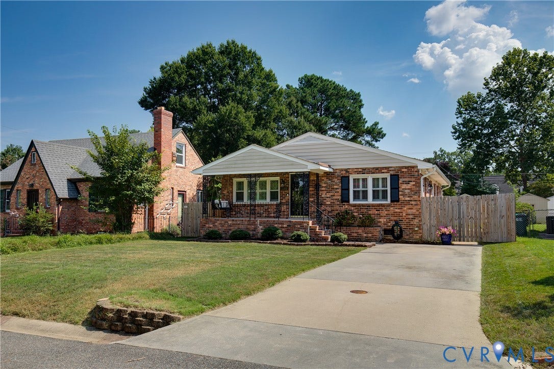 2203 Wedgewood Avenue, Henrico, VA 23228 Brick exterior with white trim, covered front porch, concrete driveway, and a wood privacy fence