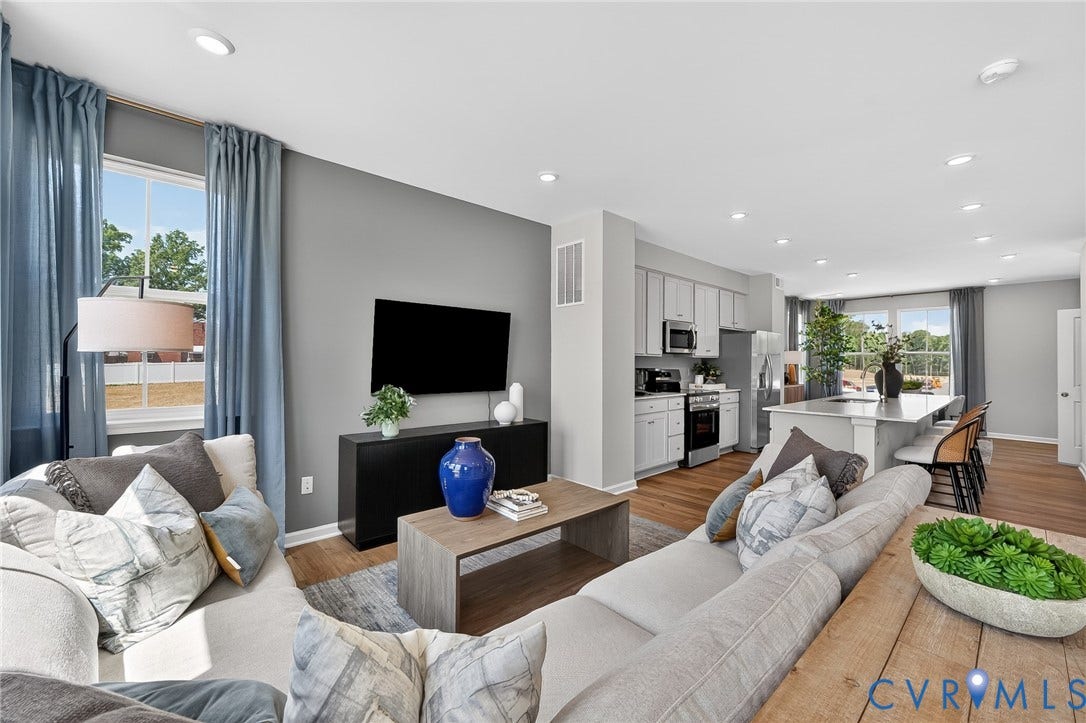 6138 Hull Street Road, Richmond, VA 23224 Open-concept living space featuring wood-finish flooring, recessed lighting, a modern kitchen with a large island, and stainless steel appliances