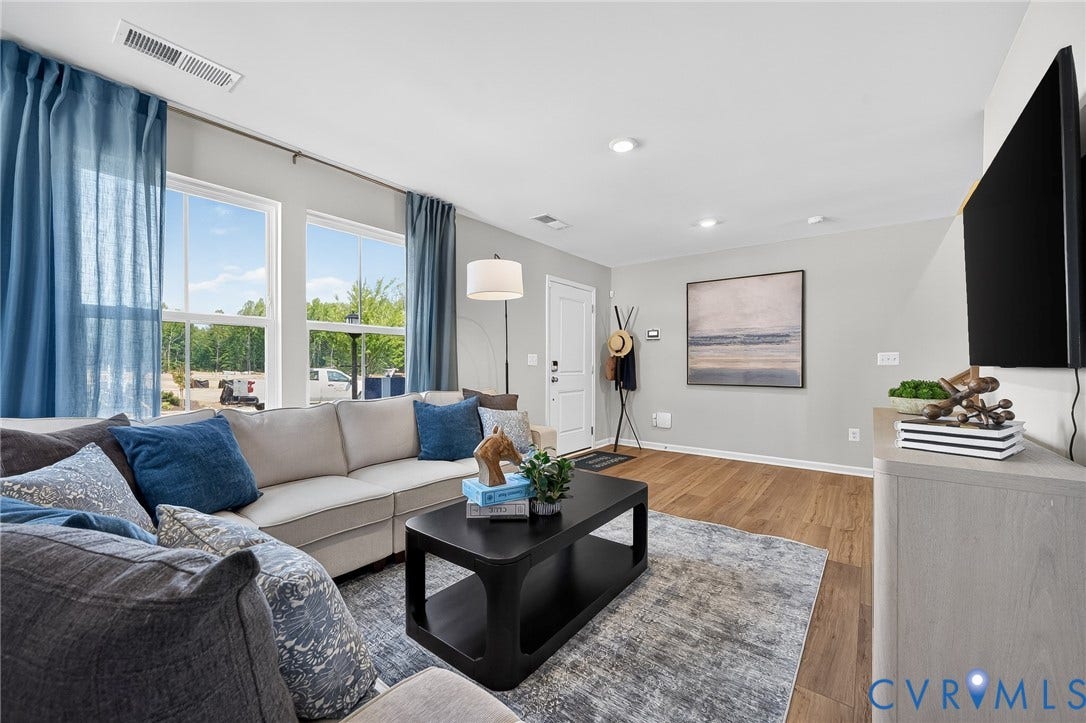 6138 Hull Street Road, Richmond, VA 23224 Recessed lighting, wood-finish flooring, white trim, and a large window