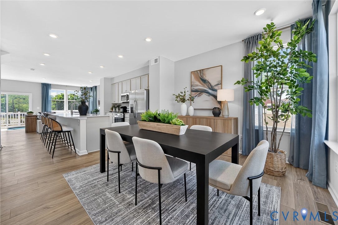 6138 Hull Street Road, Richmond, VA 23224 Wood-finish flooring throughout, recessed ceiling lighting, light gray kitchen cabinetry, stainless steel kitchen appliances, and a kitchen island with seating
