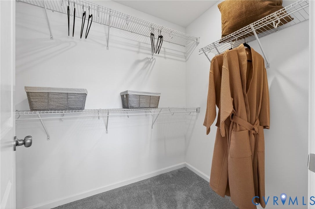 6138 Hull Street Road, Richmond, VA 23224 Walk-in closet with carpet flooring, white wire shelving, and hanging rods