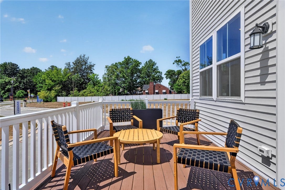 6138 Hull Street Road, Richmond, VA 23224 Outdoor deck with wood-finish flooring, white railing, and exterior wall sconce