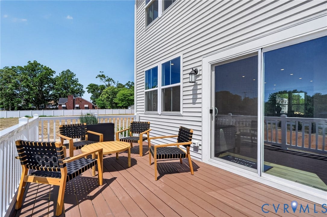 6138 Hull Street Road, Richmond, VA 23224 Spacious outdoor deck with composite flooring, white railing, and a sliding glass door