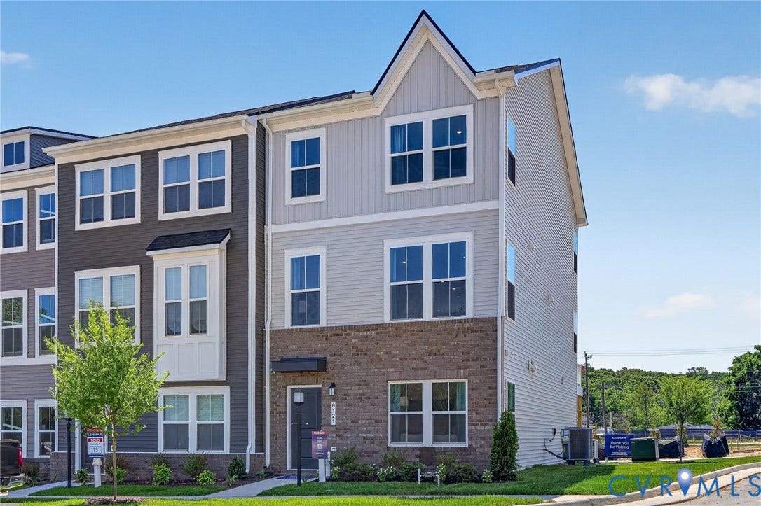 6138 Hull Street Road, Richmond, VA 23224 Modern townhome with multi-tone siding, brick accents, and a prominent gable roofline