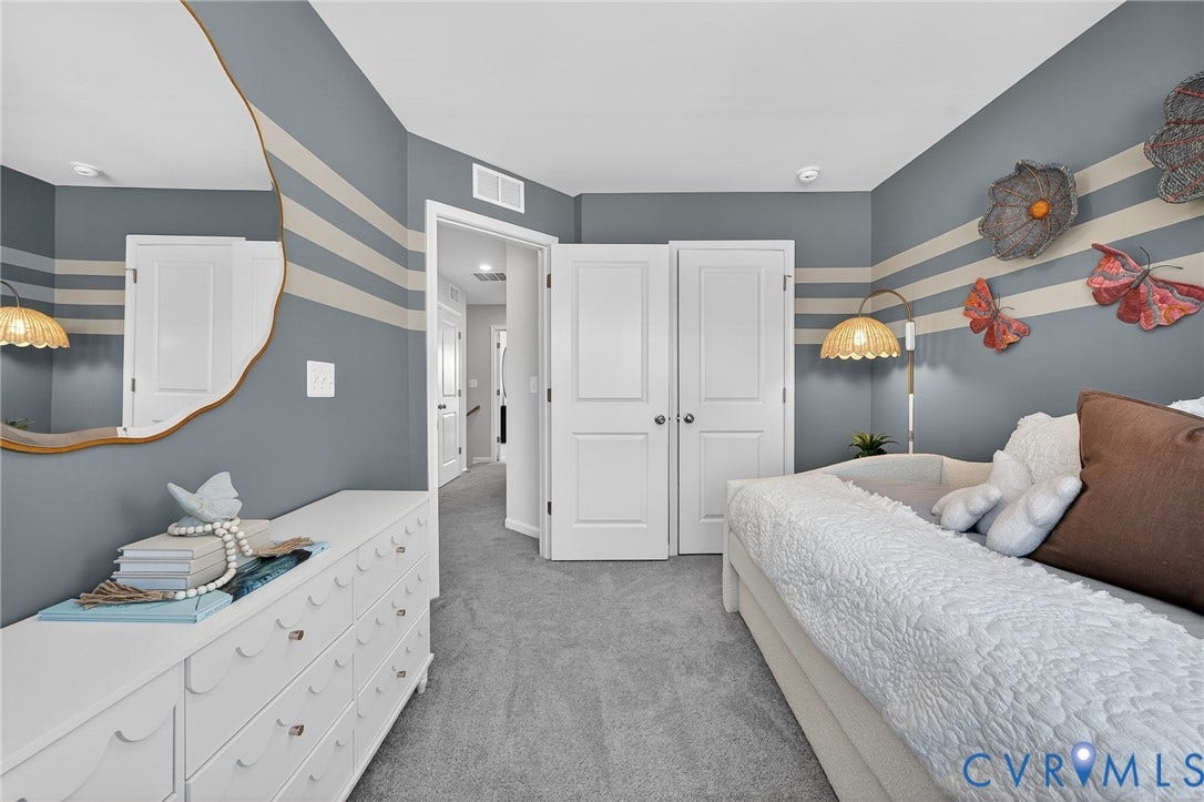 6138 Hull Street Road, Richmond, VA 23224 Wall-to-wall carpeting, painted accent wall, white paneled doors, and ceiling-mounted light fixtures