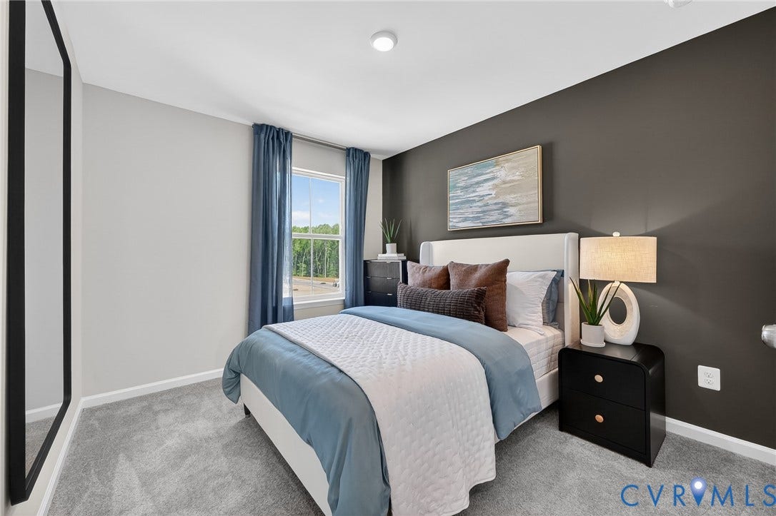 6138 Hull Street Road, Richmond, VA 23224 Plush carpeting, a window with exterior scenery, a recessed ceiling light, and a two-tone painted wall