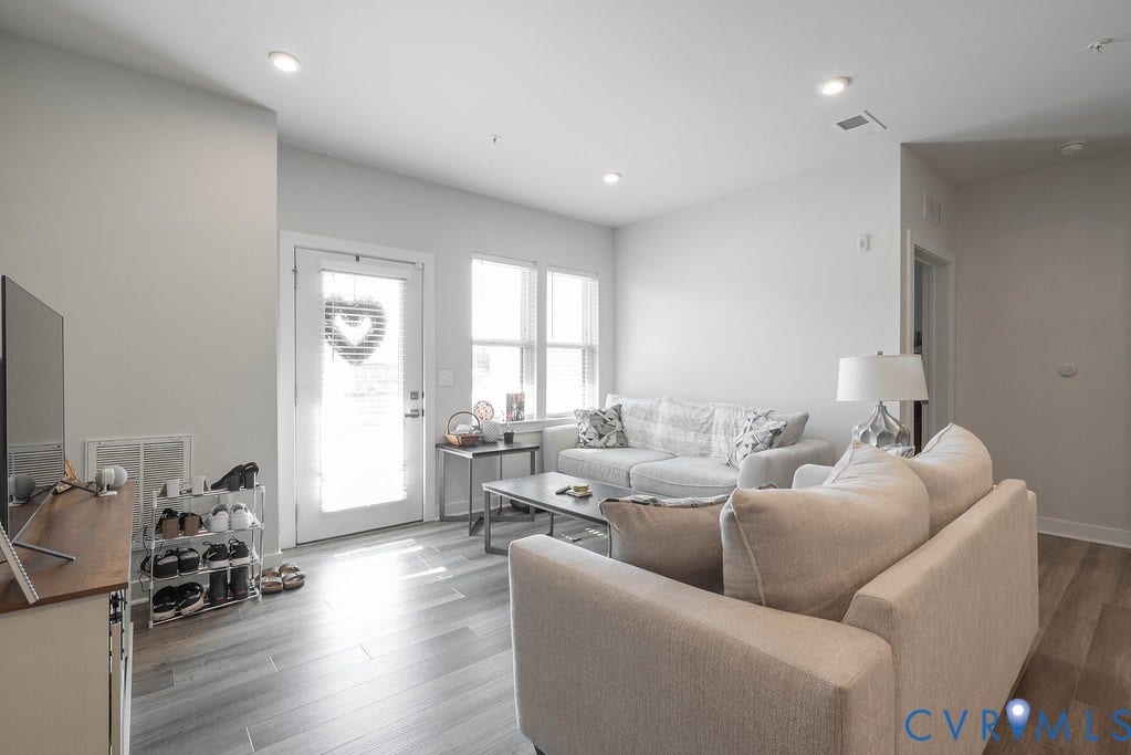 4000 Maze Runner Drive, #101, Midlothian, VA 23112 Open-concept living area featuring recessed lighting, wood-finish flooring, and multiple windows for natural light