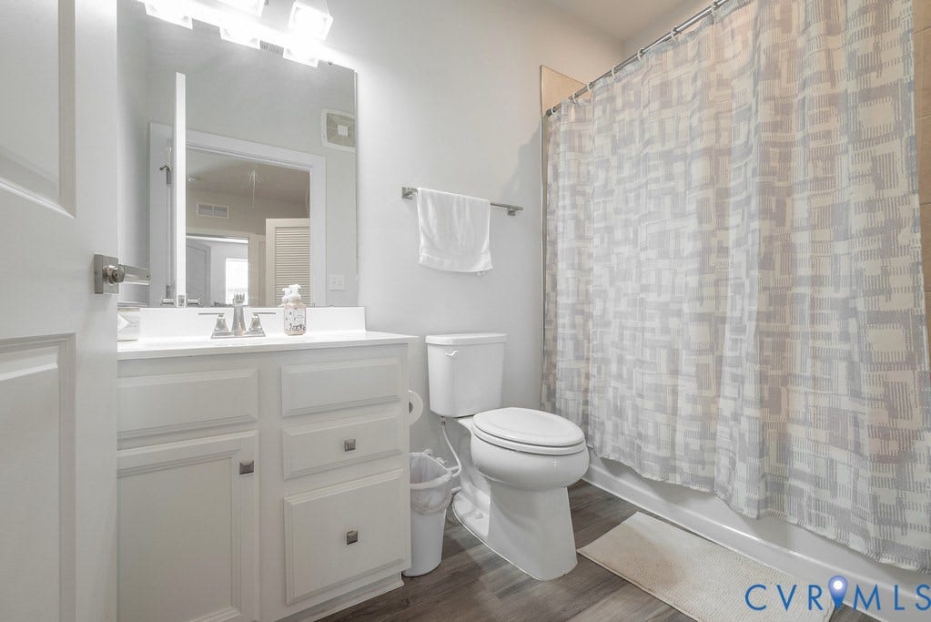 4000 Maze Runner Drive, #101, Midlothian, VA 23112 White vanity with a single basin sink, chrome faucet, and integrated mirror