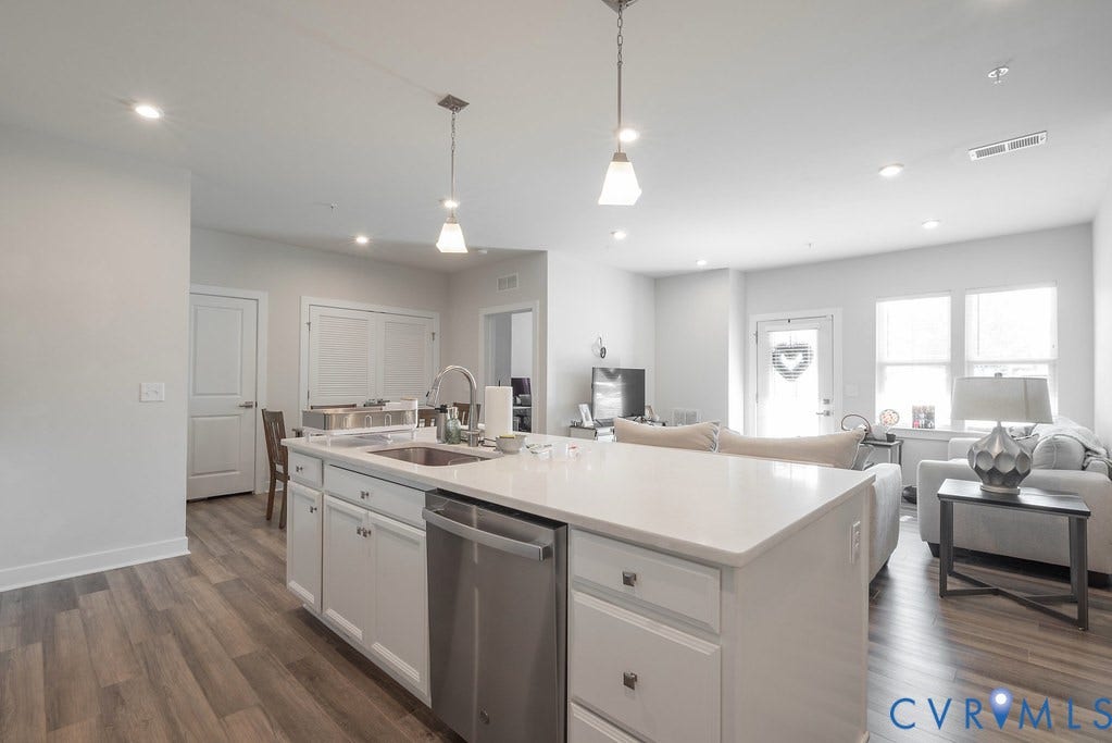 4000 Maze Runner Drive, #101, Midlothian, VA 23112 Kitchen island with white cabinetry and integrated stainless steel dishwasher