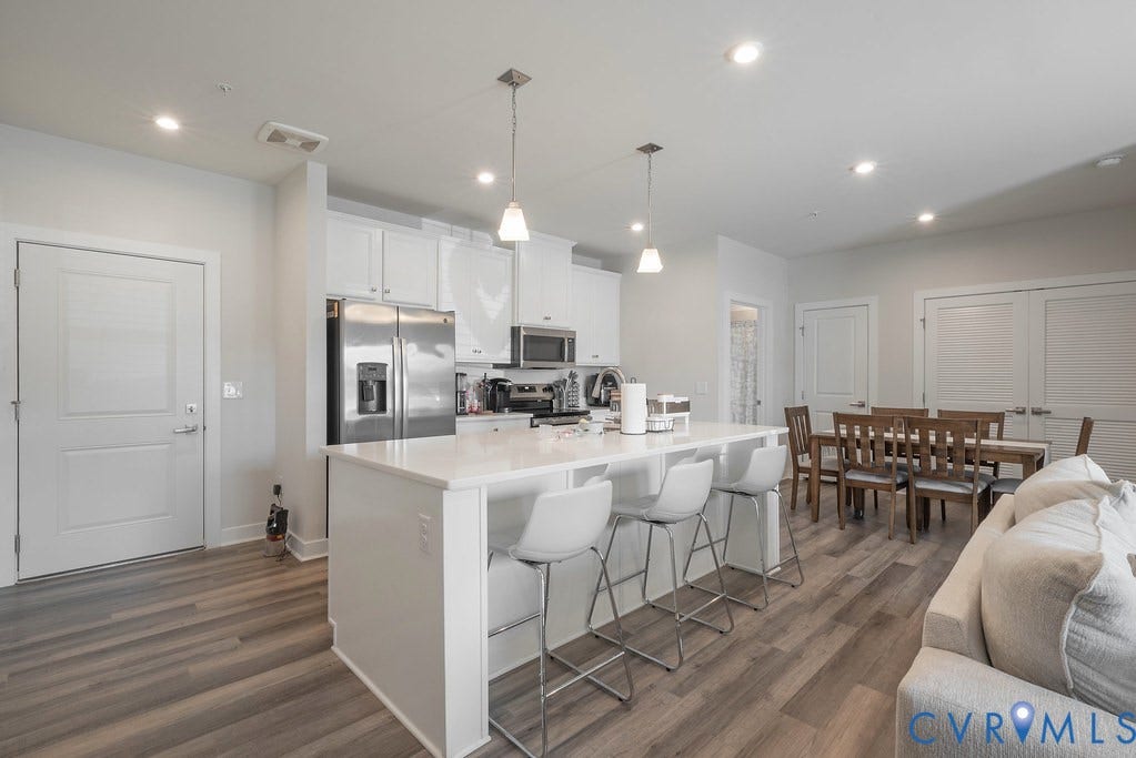 4000 Maze Runner Drive, #101, Midlothian, VA 23112 Open-concept living space featuring wood-finish flooring, recessed lighting, and a kitchen island with pendant lighting