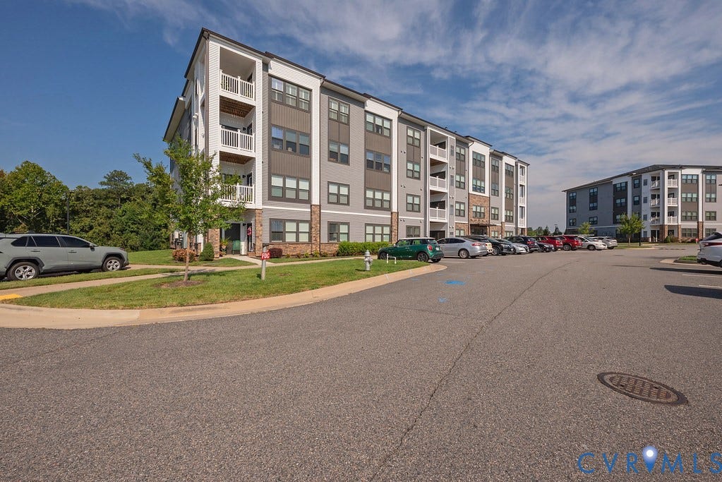 4000 Maze Runner Drive, #101, Midlothian, VA 23112 Contemporary apartment building with balconies, multi-tone siding, and stone accents