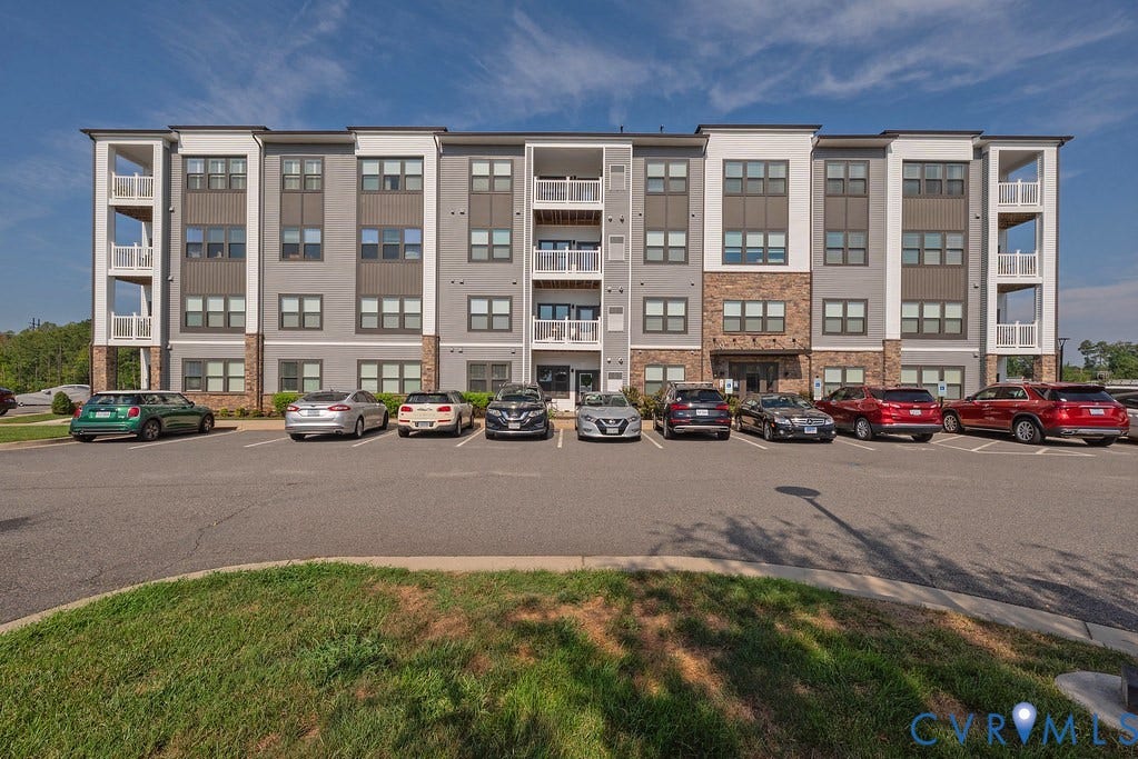 4000 Maze Runner Drive, #101, Midlothian, VA 23112 Multi-story building featuring a blend of gray siding, stone accents, and white trim