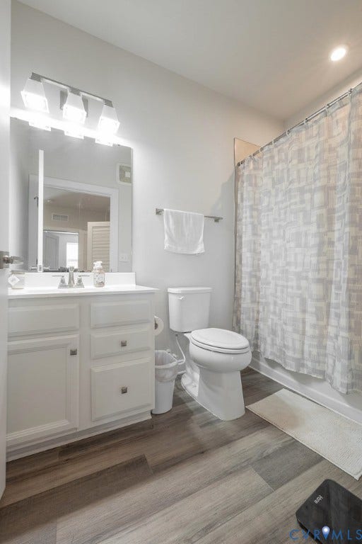 4000 Maze Runner Drive, #101, Midlothian, VA 23112 White vanity with integrated sink, wood-finish flooring, and a shower/tub combination with white tile surround