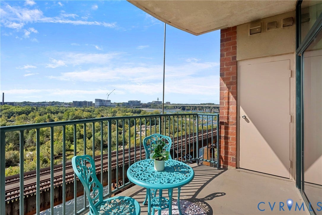 1101 Haxall Point, #U514, Richmond, VA 23219 Private balcony with durable flooring, brick exterior, metal railing, and a sliding glass door