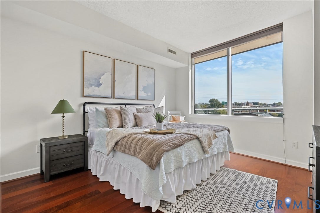 1101 Haxall Point, #U514, Richmond, VA 23219 Expansive window offering abundant natural light, rich wood-finish flooring, and white wall finishes
