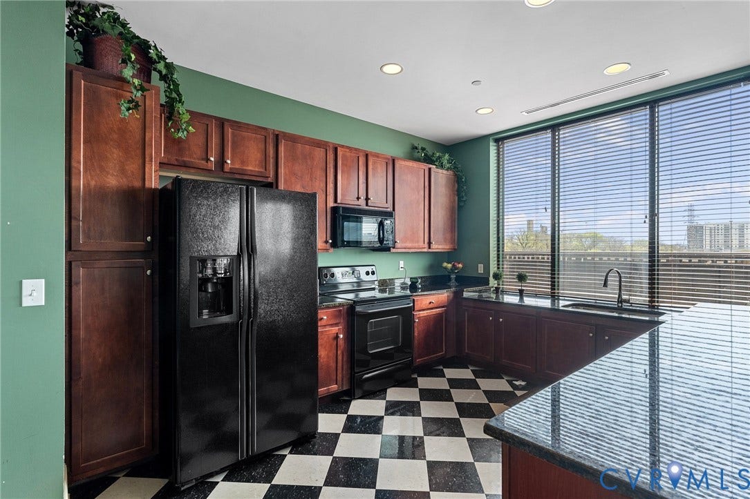 1101 Haxall Point, #U514, Richmond, VA 23219 Kitchen featuring wood cabinetry, black and white checkerboard flooring, black appliances, and dark countertops