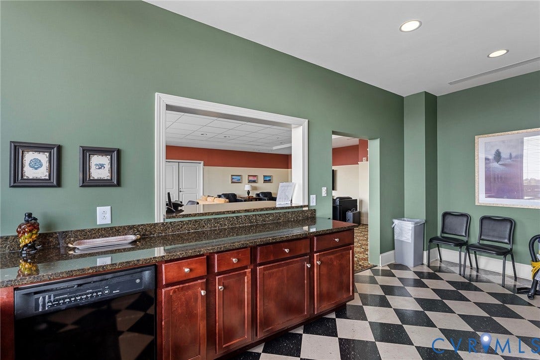 1101 Haxall Point, #U514, Richmond, VA 23219 Built-in cabinetry with dark wood finishes, a black dishwasher, and granite-style countertops