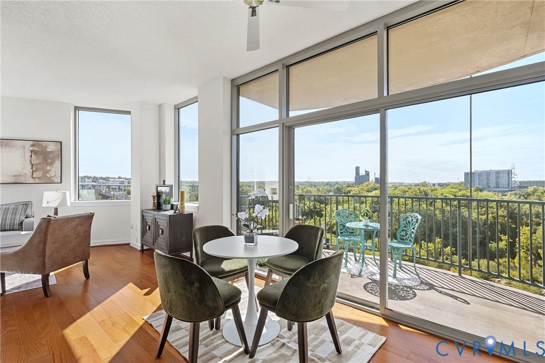 1101 Haxall Point, #U514, Richmond, VA 23219 Expansive windows with roller shades, glass sliding door to a balcony, wood-finish flooring, and ceiling fan