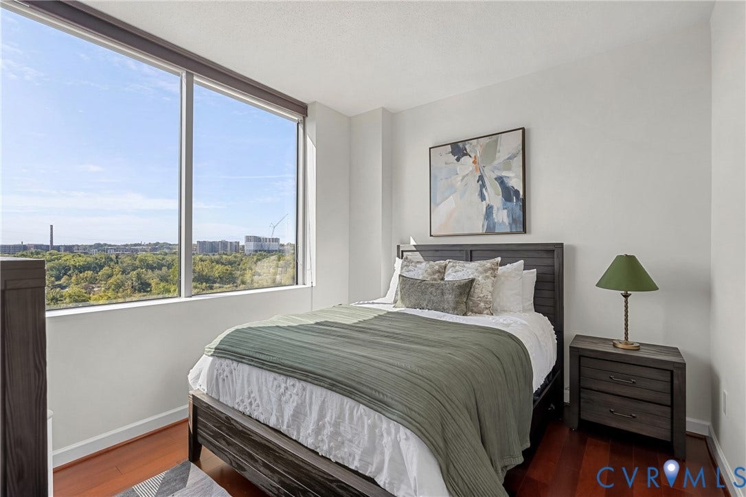 1101 Haxall Point, #U514, Richmond, VA 23219 Expansive window with roller shades, wood-finish flooring, and white painted walls