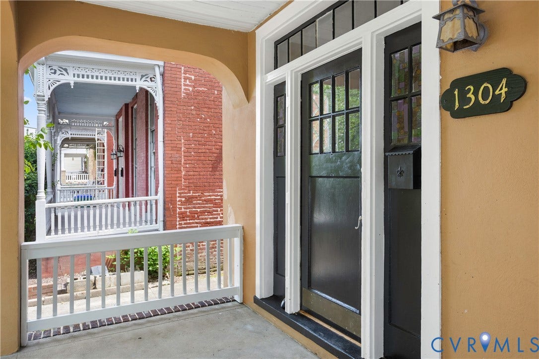 1304 Bainbridge Street, Manchester, Richmond, VA 23224 Covered front entry featuring a solid wood door with multi-pane glass, sidelights, and transom windows