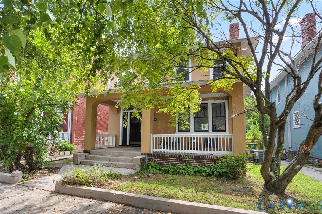 1304 Bainbridge Street, Manchester, Richmond, VA 23224 Tan stucco exterior with a covered front porch featuring white railings