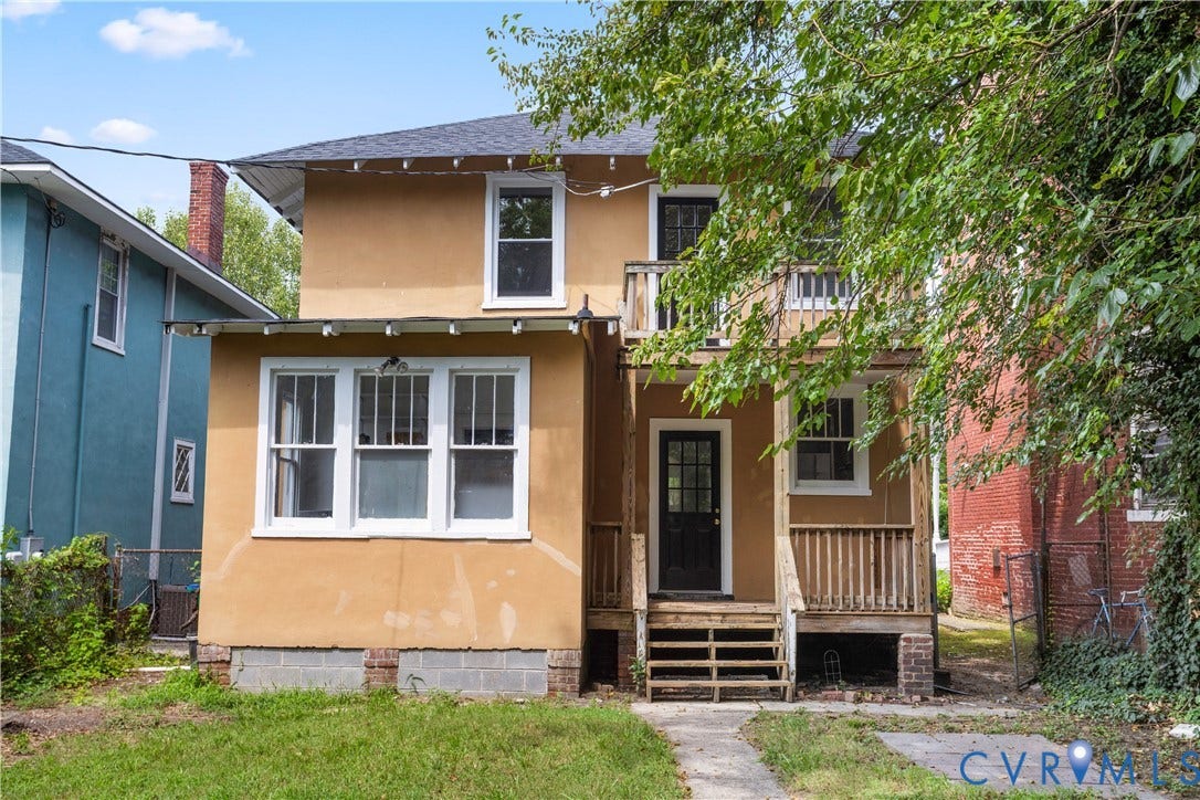 1304 Bainbridge Street, Manchester, Richmond, VA 23224 Two-story exterior with a second-level balcony, ground-level porch, and a rear entrance