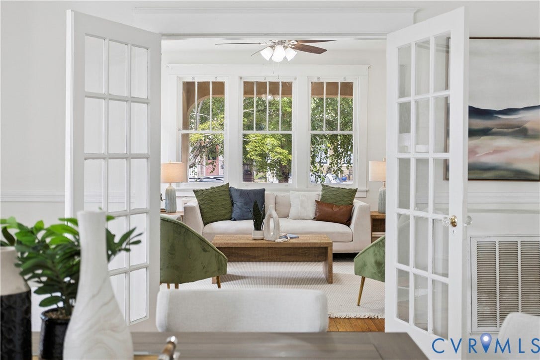 1304 Bainbridge Street, Manchester, Richmond, VA 23224 French doors with clear glass panes, three large windows with upper transoms, and a ceiling fan with light fixture