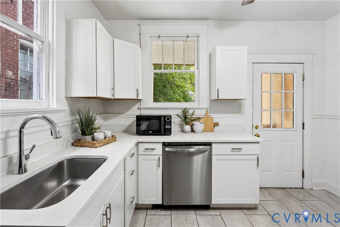 1304 Bainbridge Street, Manchester, Richmond, VA 23224 White cabinetry, stainless steel sink, chrome faucet, white countertops, and light-colored tile flooring