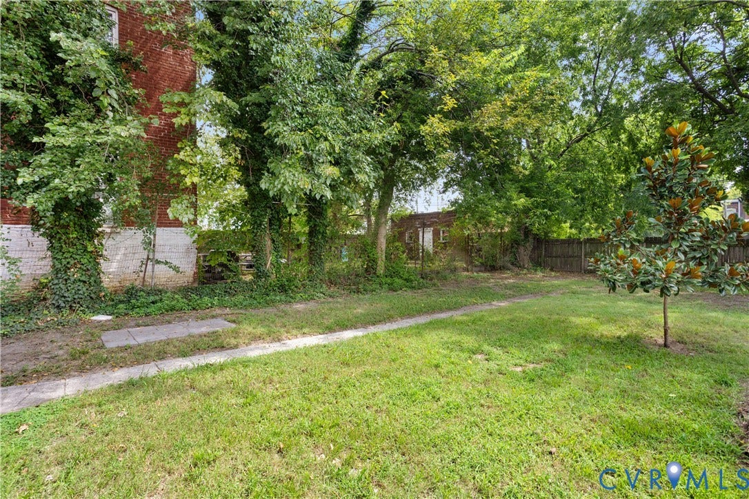 1304 Bainbridge Street, Manchester, Richmond, VA 23224 Expansive grassy area featuring mature trees and a young magnolia tree