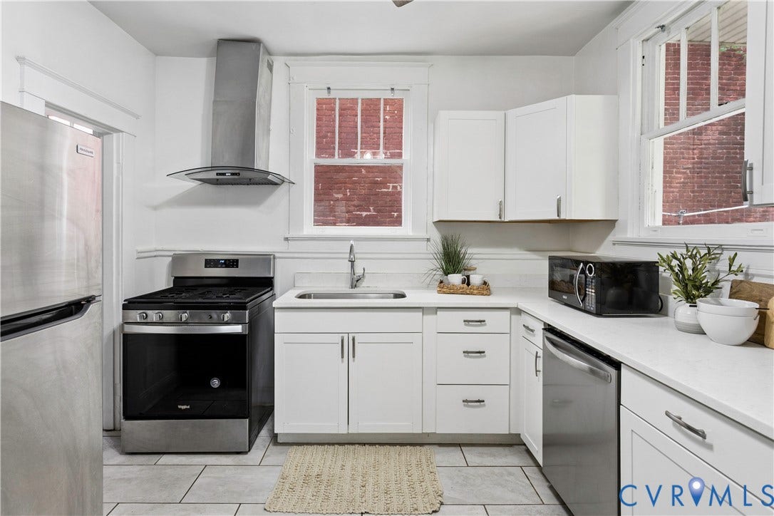 1304 Bainbridge Street, Manchester, Richmond, VA 23224 White shaker cabinetry, stainless steel appliances, light-toned countertops, and tiled flooring