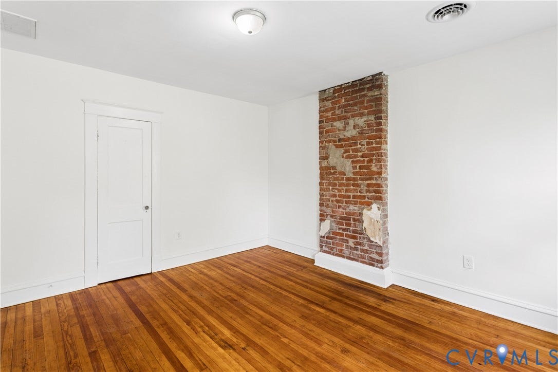 1304 Bainbridge Street, Manchester, Richmond, VA 23224 Exposed brick architectural element with wood-finish flooring