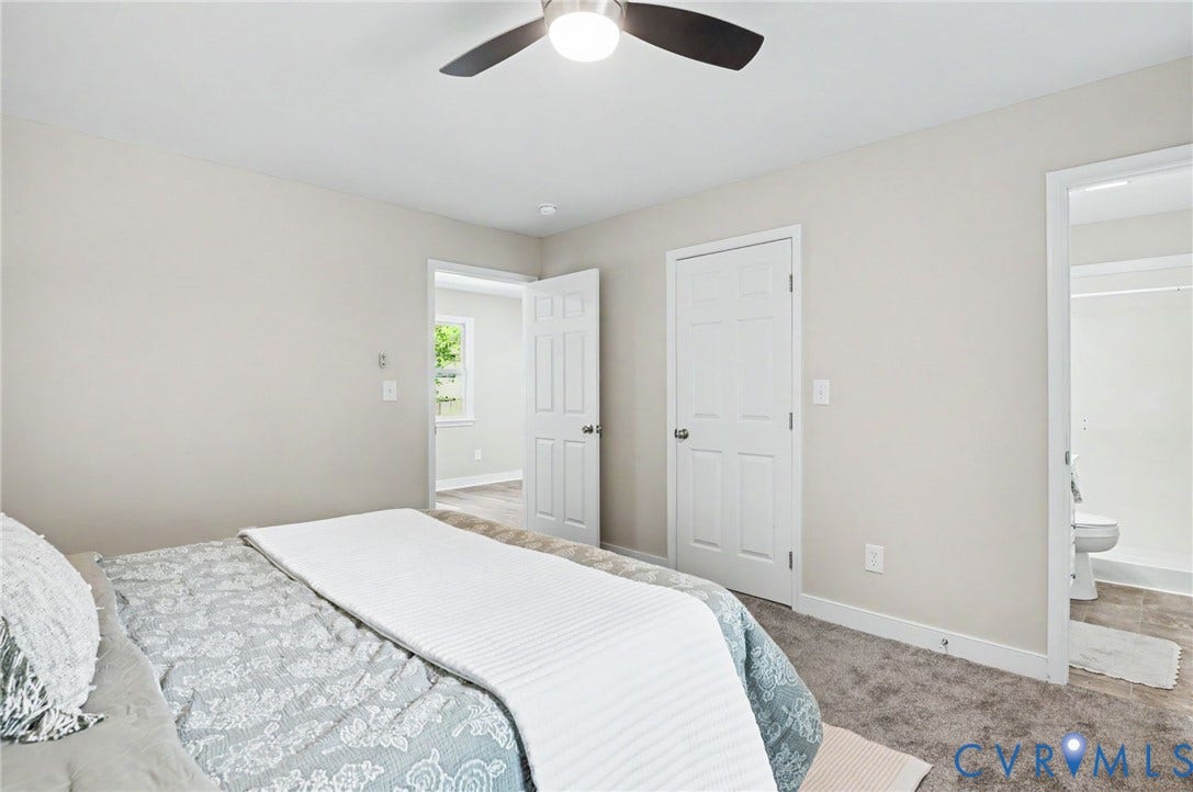 Neutral wall finishes and gray carpeting