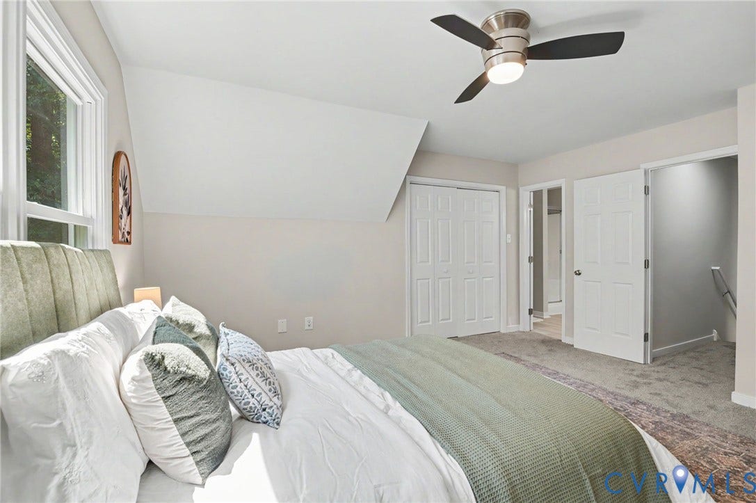 Sloped ceiling, recessed window, ceiling fan with integrated lighting, bi-fold closet doors, paneled doors
