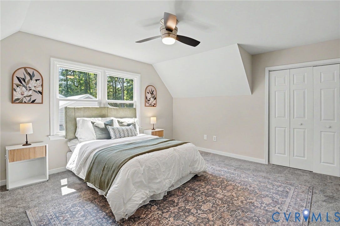 Vaulted ceiling with a ceiling fan, dual windows, and bifold closet doors