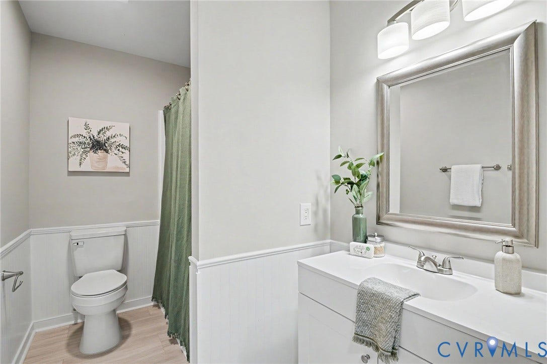 White vanity with an integrated sink and chrome faucet